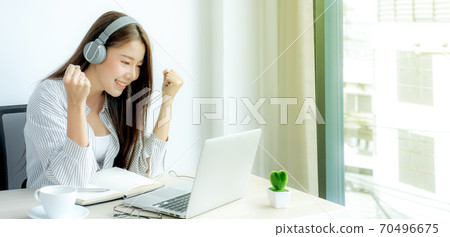 Young Asian teachers are teaching fun online from their home office, social distancing teaching concept during COVID virus diseases 70496675