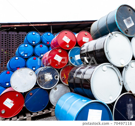 Stack of old chemical barrels. Blue, black and red oil drum. Steel and plastic oil tank. Toxic waste warehouse. Hazard chemical barrel. Industrial waste in drum. Hazard waste storage in factory. 70497118