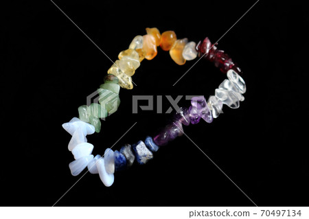 Colorful crystal chakras bracelet isolated on black 70497134