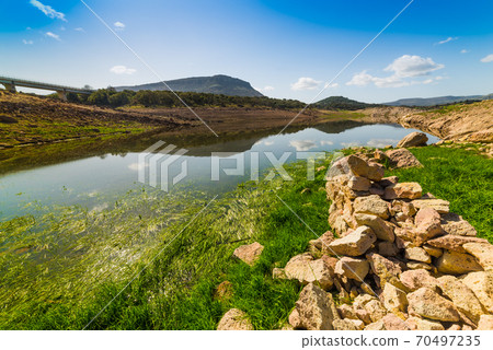 Rocks and vegetation in Temo lake shore 70497235