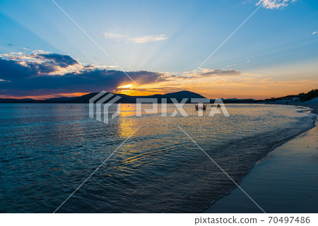 Colorful sky over Alghero shore at sunset 70497486