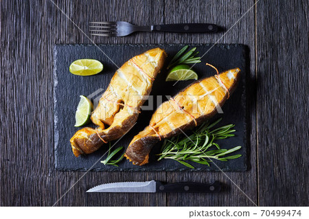Traditional smoked halibut fish steaks with lime Traditional smoked halibut fish steaks with lime 70499474