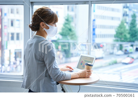 Woman doing standing work 70500161