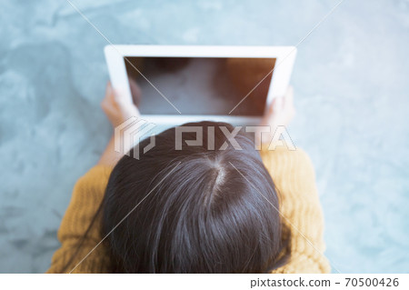 Children's photo material looking at the screen on a tablet PC in the room Children's photo material looking at the screen on a tablet PC in the room 70500426