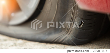 Close up Wheel has big Hole burst and flat tire car because glass hit puncture inside during driving on road. Concept unexpected crash accident Close up Wheel has big Hole burst and flat tire car because glass hit puncture inside during driving on road. Concept unexpected crash accident 70501004