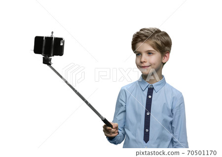 Happy boy making a selfie on white background. 70501170
