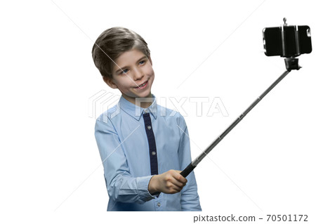 Happy little boy taking selfie using a stick. Happy little boy taking selfie using a stick. 70501172