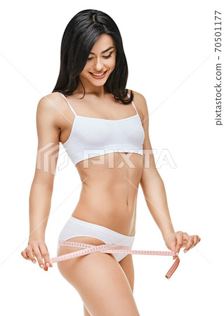 Slim tanned woman's body isolated on white background - waist measurement 70501177