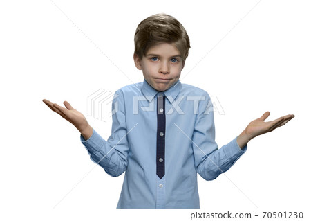 Little boy shrugging shoulders expressing doubt or lack of knowledge. Little boy shrugging shoulders expressing doubt or lack of knowledge. 70501230
