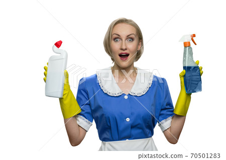 Surprised maid with open mouth holding cleaner spray and toilet disinfectant on white background. 70501283