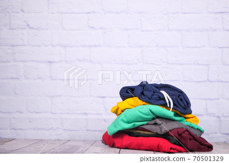 close up of stack of clothes on table . 70501329