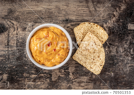 Traditional Mexican cheese sauce and nacho chips 70501353