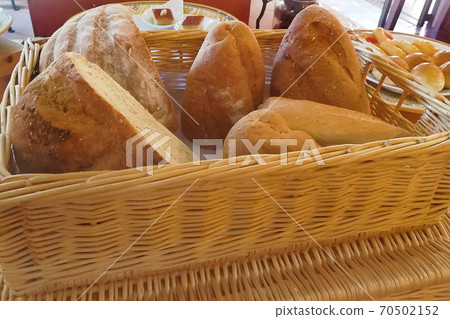 Varieties of daily fresh bread bakery in beautiful wicker basket on wood table and old wooden wall in background Varieties of daily fresh bread bakery in beautiful wicker basket on wood table and old wooden wall in background 70502152