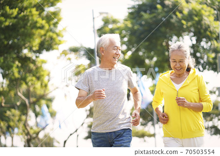 happy asian senior couple running exercising outdoors in park 70503554