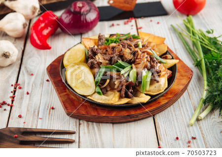 Fried potatoes with beef in cast iron pan Fried potatoes with beef in cast iron pan 70503723