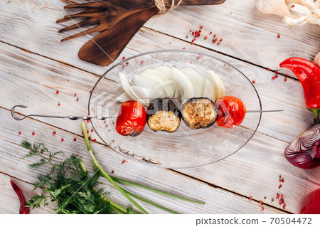 Grilled vegetable skewers with eggplant and tomato 70504472