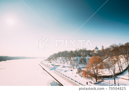 Gomel, Belarus. Winter City Park, Frozen River, Embankment And Peter And Paul Cathedral In Sunny Winter Day. Famous Local Landmark In Snow 70504825