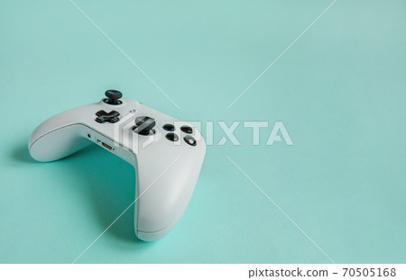 Cyberspace symbol. White joystick gamepad, game console isolated on pastel blue colourful trendy background. Computer gaming competition videogame control confrontation concept. Cyberspace symbol. White joystick gamepad, game console isolated on pastel blue colourful trendy background. Computer gaming competition videogame control confrontation concept. 70505168