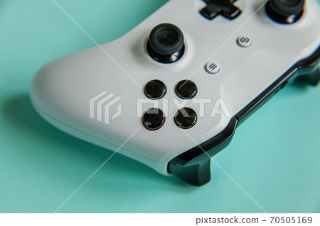 Cyberspace symbol. White joystick gamepad, game console isolated on pastel blue colourful trendy background. Computer gaming competition videogame control confrontation concept. Cyberspace symbol. White joystick gamepad, game console isolated on pastel blue colourful trendy background. Computer gaming competition videogame control confrontation concept. 70505169