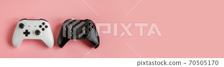 White and black two joystick gamepad game console isolated on pastel pink colourful background. Computer gaming competition videogame control confrontation concept. Cyberspace symbol Banner White and black two joystick gamepad game console isolated on pastel pink colourful background. Computer gaming competition videogame control confrontation concept. Cyberspace symbol Banner 70505170