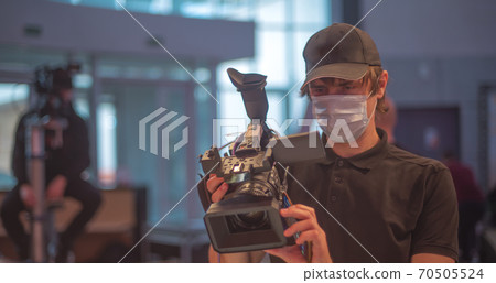 masked journalists interviewing during a pandemic. 70505524