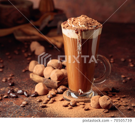 Truffles and glass of hot chocolate with whipped cream. Truffles and glass of hot chocolate with whipped cream. 70505739