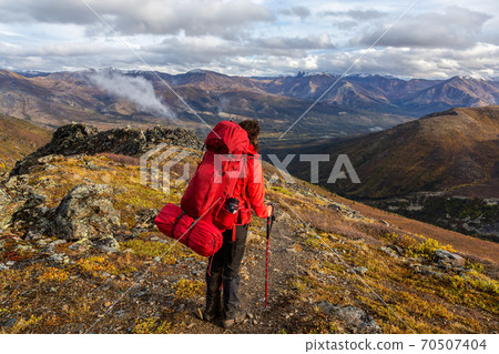 Woman Backpacking in Scenic Mountain Landscape 70507404