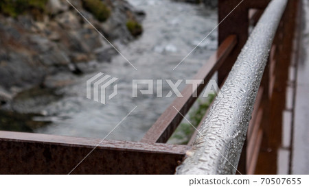 Rain water drops macro on shiny rusty metal bridge 70507655