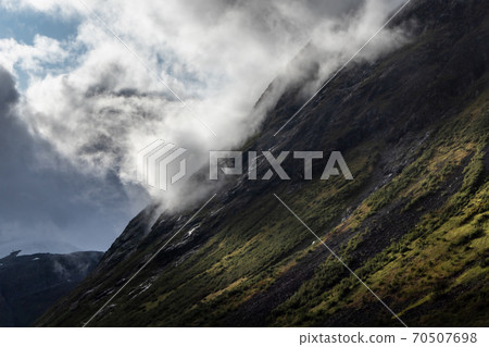 Mountain peak with clouds and bright sun rays 70507698