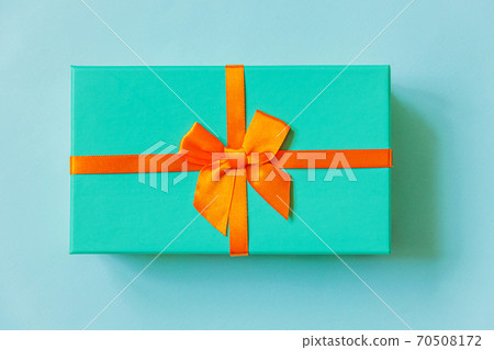 Christmas New Year birthday valentine celebration present romantic concept. Simply minimal design blue gift box isolated on pastel blue colorful background. Flat lay top view, copy space Christmas New Year birthday valentine celebration present romantic concept. Simply minimal design blue gift box isolated on pastel blue colorful background. Flat lay top view, copy space 70508172