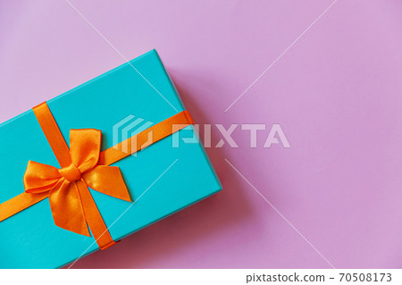 Christmas New Year birthday valentine celebration present romantic concept. Simply minimal design blue gift box isolated on violet purple colorful background. Flat lay top view, copy space Christmas New Year birthday valentine celebration present romantic concept. Simply minimal design blue gift box isolated on violet purple colorful background. Flat lay top view, copy space 70508173