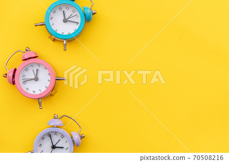 Simply minimal design three ringing twin bell classic alarm clock Isolated on yellow background. Rest hours time of life good morning night wake up awake concept. Flat lay top view copy space. Simply minimal design three ringing twin bell classic alarm clock Isolated on yellow background. Rest hours time of life good morning night wake up awake concept. Flat lay top view copy space. 70508216