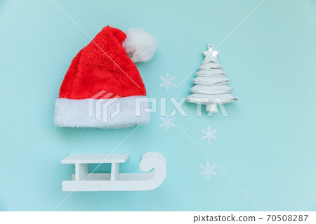 Simply minimal composition winter objects ornament Santa hat sled fir tree isolated on blue pastel trendy background Simply minimal composition winter objects ornament Santa hat sled fir tree isolated on blue pastel trendy background 70508287