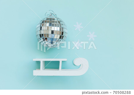 Simply minimal composition winter objects ornament ball sled isolated on blue pastel trendy background 70508288