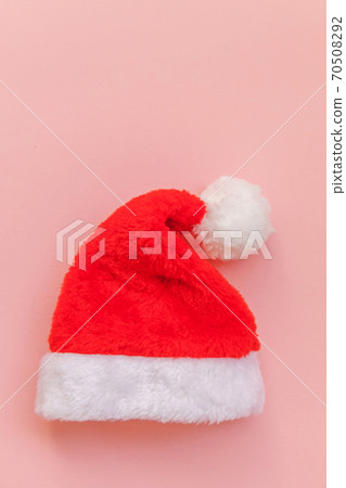 Simply minimal design Christmas Santa Claus hat isolated on pink pastel colorful trendy background Simply minimal design Christmas Santa Claus hat isolated on pink pastel colorful trendy background 70508292