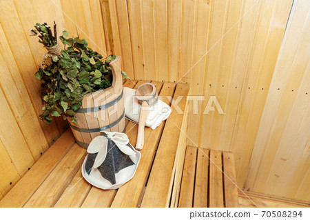 Interior details Finnish sauna steam room with traditional sauna accessories basin birch broom scoop felt hat towel. Traditional old Russian bathhouse SPA Concept. Relax country village bath concept. 70508294