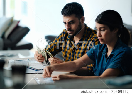 Couple Doing Home Budget Counting Money To Pay Bills Couple Doing Home Budget Counting Money To Pay Bills 70509112