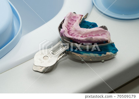 impressions for the manufacture of dental prostheses, molds for ceramic crowns, lay on white table 70509179