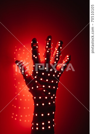 human hand covered with red led lights, illuminated background 70510105