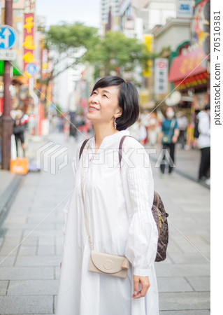 A refreshing middle-aged senior woman enjoying Yokohama Chinatown 70510381