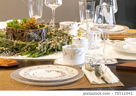 Elegant table set for Christmas dinner Elegant table set for Christmas dinner 70512041