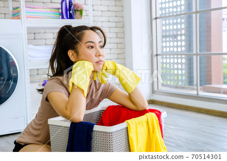 woman frustrated with washing clothes 70514301