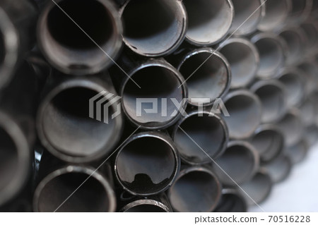 Black metal pipes for gasification or water supply. Industrial background close up Black metal pipes for gasification or water supply. Industrial background close up 70516228