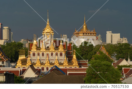 Loha Prasat Wat Ratchanatda and Golden Mountain pagoda, a buddhist temple or Wat Saket with skyscraper buildings in Bangkok Downtown, urban city, Thailand. Thai Landmark. Architecture. 70517530