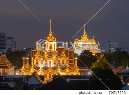 Loha Prasat Wat Ratchanatda and Golden Mountain pagoda, a buddhist temple or Wat Saket with skyscraper buildings in Bangkok Downtown, urban city, Thailand. Thai Landmark. Architecture. 70517533