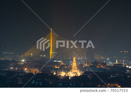 Aerial view of Rama 8 Bridge and Temple of Dawn or Wat Arun in Rattanakosin Island in architecture, Urban old town city, Bangkok skyline. downtown area, Thailand at night. Aerial view of Rama 8 Bridge and Temple of Dawn or Wat Arun in Rattanakosin Island in architecture, Urban old town city, Bangkok skyline. downtown area, Thailand at night. 70517553