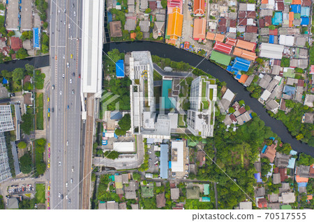 Aerial top view of sky garden on private rooftop of condominium or hotel with swimming pool, high rise architecture building with tree, grass field. 70517555