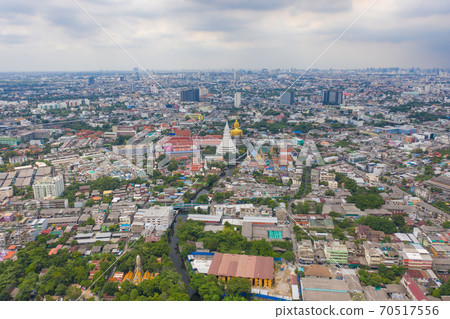 Aerial view of the Giant Golden Buddha in Wat Paknam Phasi Charoen Temple in Phasi Charoen district at sunset, Bangkok. Urban town, Thailand. Downtown City. 70517556