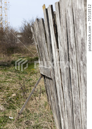 an old wooden fence that is broken an old wooden fence that is broken 70518512