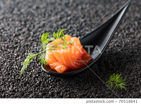 Salted salmon with dill on the background of black sesame. 70518641